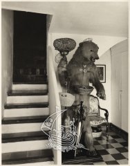 A photograph of Salvador Dalí's House in Portlligat, as can be found now. In the image we see the figure of a bear, made by Salvador Dalí, next to a staircases.