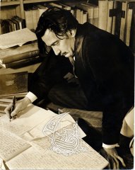 Photograph of Salvador Dalí writing a book.