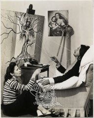 Photograph of Gala and Salvador Dalí while the artist was creating one of his works.