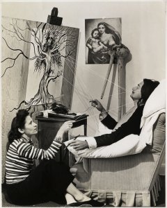 Photograph of Gala and Salvador Dalí while the artist was creating one of his works.