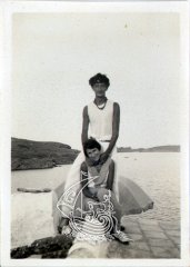 Black and white photograph of Salvador Dali and his muse Gala. They are on the roof of his house in Portlligat, and at their back you can see the sea.