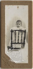 A photograph of Salvador Dalí when he was a kid, sitting on a chair.