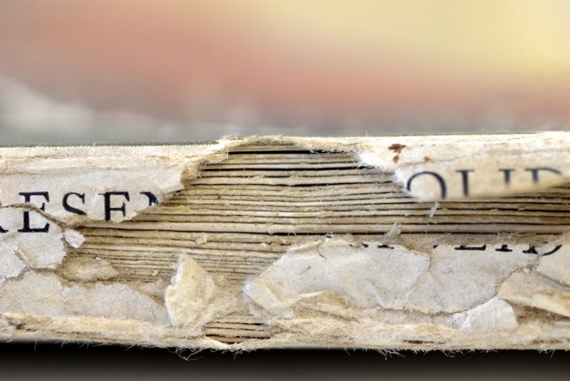 Torn spine of a magazine before its restoration